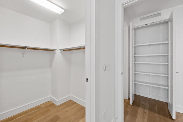 walk in closet featuring hardwood / wood-style floors