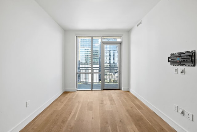 spare room with light hardwood / wood-style flooring