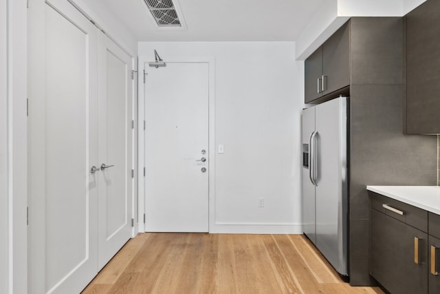 clothes washing area featuring light wood-type flooring