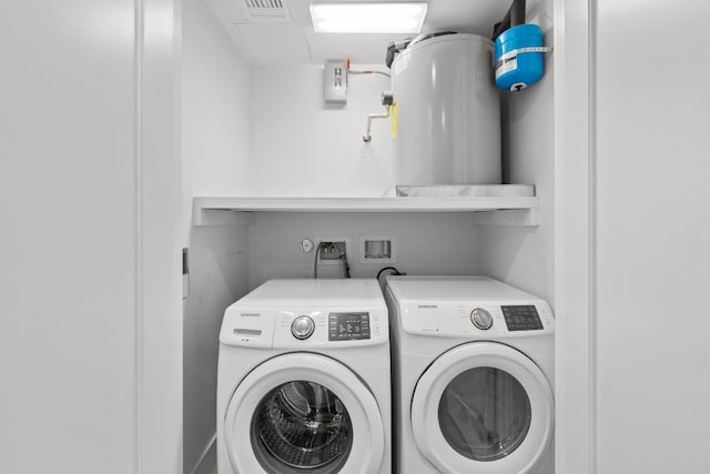 clothes washing area with washer and clothes dryer