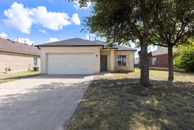 ranch-style home featuring a garage and a front lawn