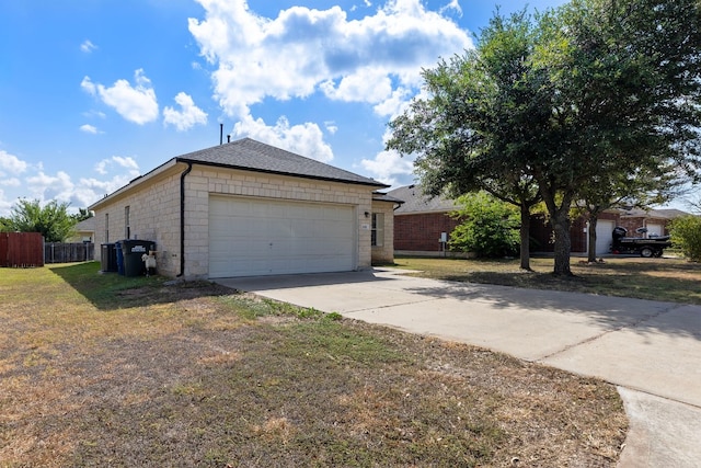 view of front of property featuring a front yard and a garage