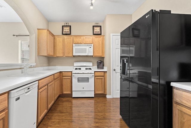 kitchen with dark wood-type flooring, white appliances, and sink