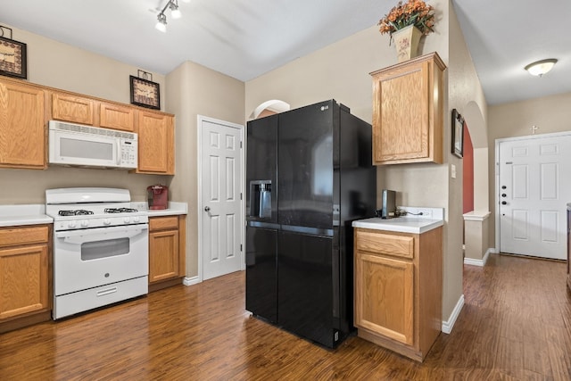 kitchen with dark hardwood / wood-style floors and white appliances