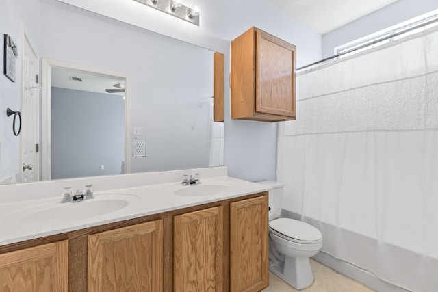 full bathroom with shower / bath combination with curtain, toilet, and vanity