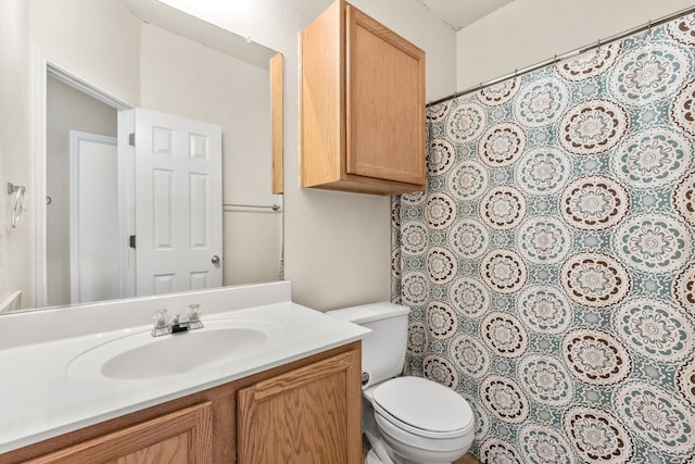 bathroom with toilet and vanity