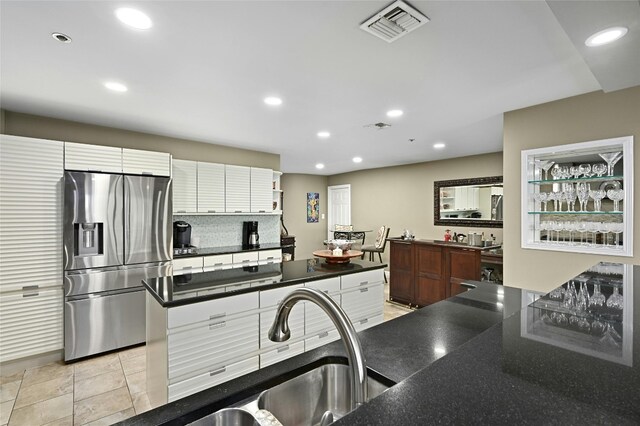 40 N Interstate Highway 35 Unit 8C1, Austin, TX 78701 - kitchen with stainless steel refrigerator with ice dispenser, recessed lighting, and decorative backsplash