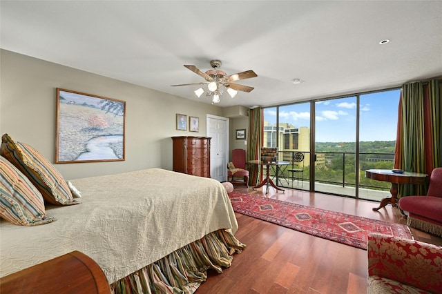 40 N Interstate Highway 35 Unit 8C1, Austin, TX 78701 - bedroom featuring access to exterior, wood finished floors, a wall of windows, and ceiling fan