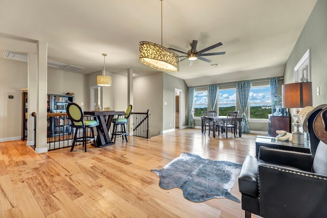 living room featuring light hardwood / wood-style flooring and ceiling fan