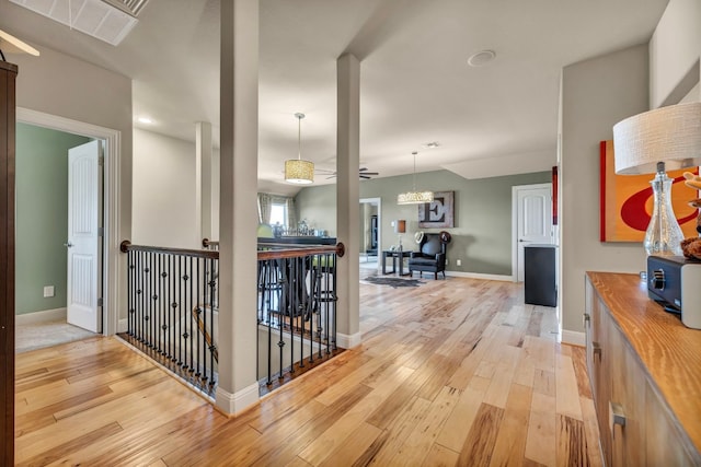 4309 Vista Verde Dr, Austin, TX 78732 - hall with light wood-type flooring, baseboards, visible vents, and an upstairs landing