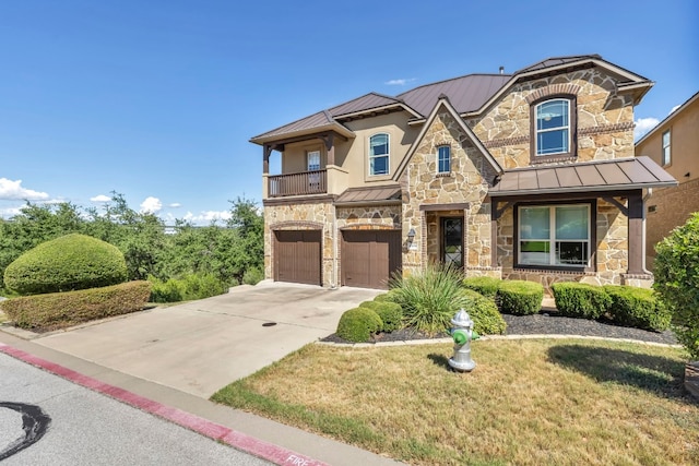 4309 Vista Verde Dr, Austin, TX 78732 - view of front of property featuring a standing seam roof, metal roof, stone siding, and a garage