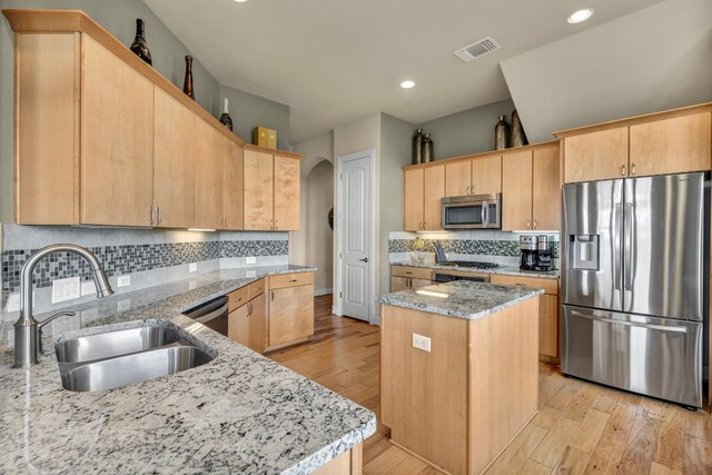 4309 Vista Verde Dr, Austin, TX 78732 - kitchen featuring a sink, appliances with stainless steel finishes, light brown cabinets, and light stone countertops