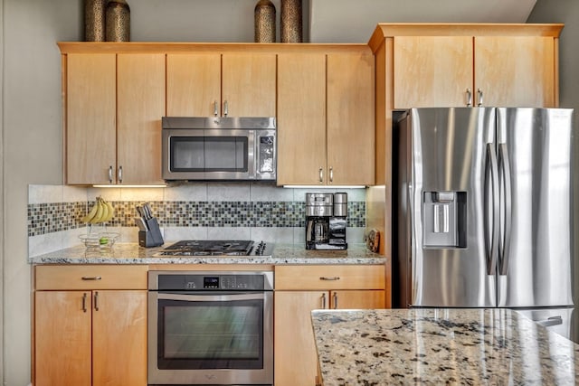 kitchen with tasteful backsplash, light stone counters, stainless steel appliances, and light brown cabinets