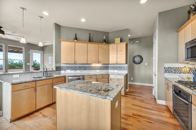 4309 Vista Verde Dr, Austin, TX 78732 - kitchen with backsplash, a sink, a peninsula, light brown cabinets, and stainless steel appliances