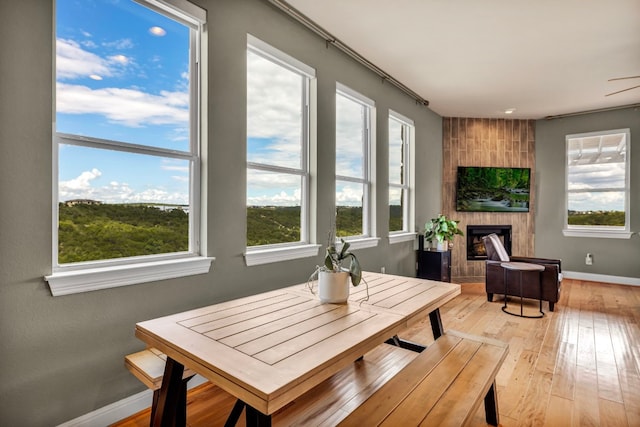 sunroom / solarium featuring a large fireplace and plenty of natural light