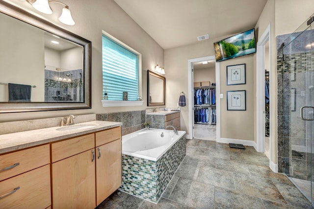 bathroom featuring independent shower and bath and vanity