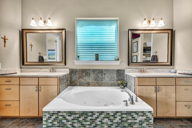 bathroom featuring vanity and tiled bath