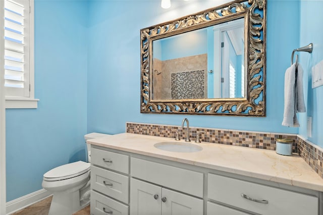 bathroom featuring toilet, a shower, backsplash, tile patterned floors, and vanity