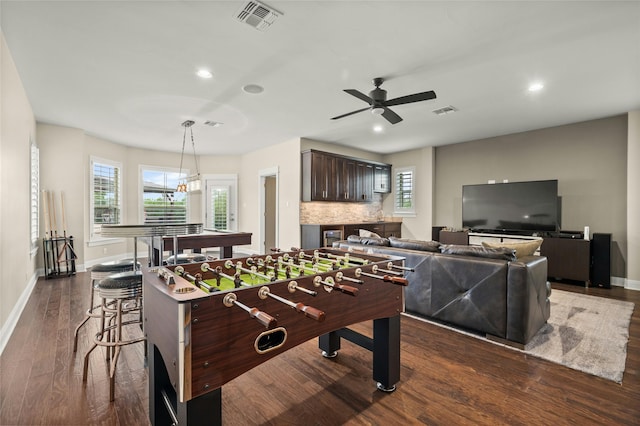 recreation room featuring ceiling fan and dark hardwood / wood-style flooring