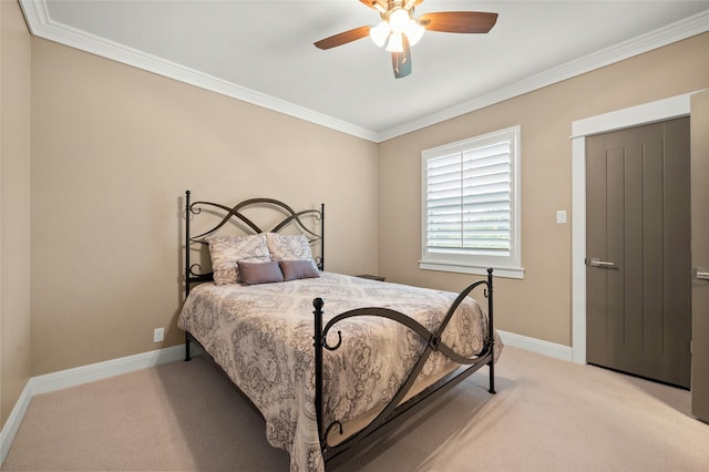 carpeted bedroom with ceiling fan and crown molding