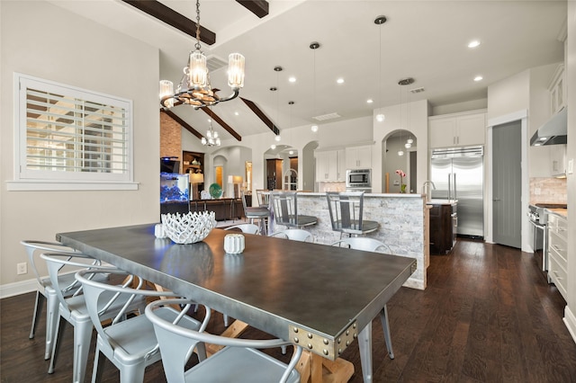 dining space with lofted ceiling with beams, dark wood-type flooring, and an inviting chandelier