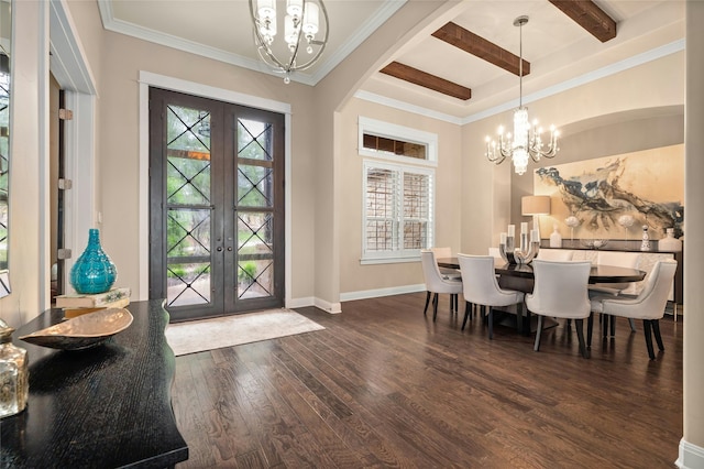 entrance foyer with a healthy amount of sunlight, a notable chandelier, dark hardwood / wood-style flooring, french doors, and beamed ceiling