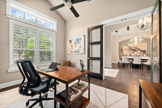 office area with vaulted ceiling, dark wood-type flooring, and ceiling fan with notable chandelier