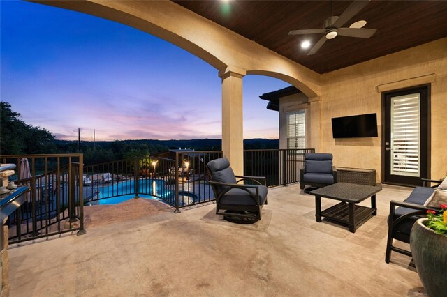 view of swimming pool with ceiling fan and a patio area