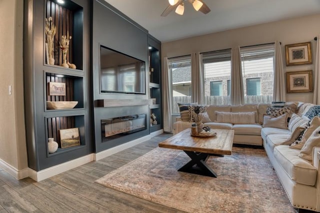 living room with hardwood / wood-style floors, ceiling fan, and built in features