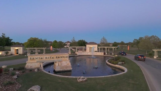 view of pool at dusk