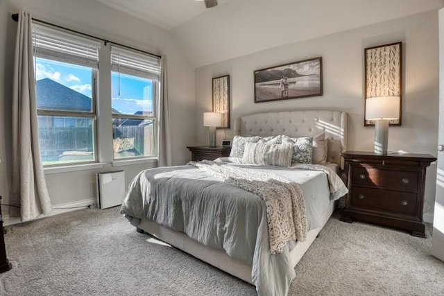 carpeted bedroom with lofted ceiling