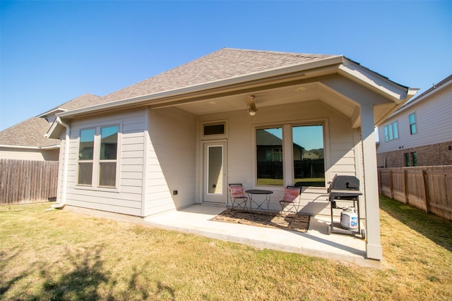 rear view of property with a patio area and a lawn