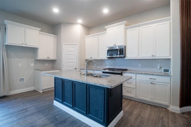 kitchen with white cabinetry, sink, a kitchen island with sink, stainless steel appliances, and dark wood-type flooring