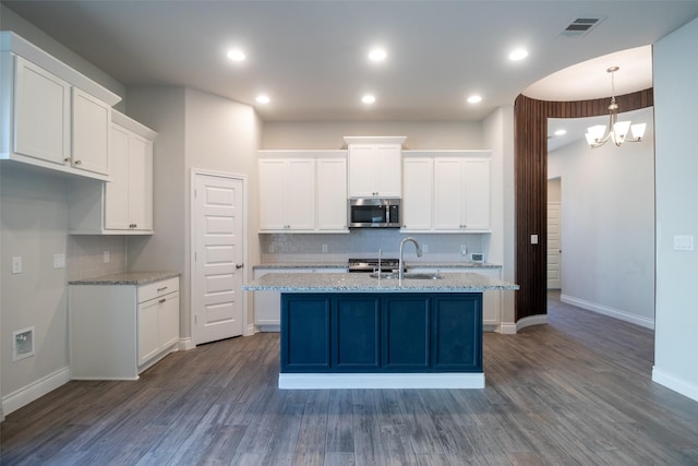 kitchen with hanging light fixtures, dark hardwood / wood-style floors, and white cabinets