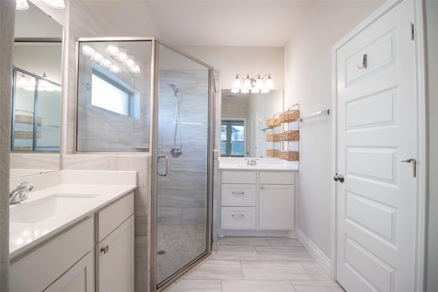 bathroom with vanity and a shower with shower door