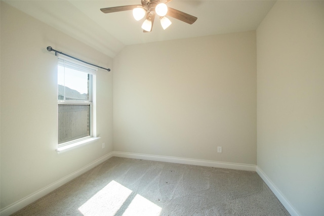 carpeted empty room with vaulted ceiling and ceiling fan