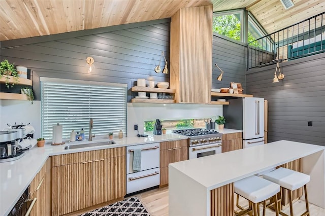 kitchen with open shelves, gas range, wood ceiling, freestanding refrigerator, and a sink