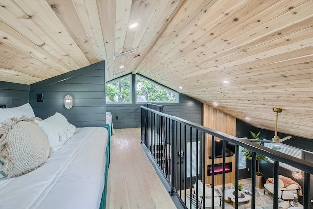 bedroom with recessed lighting, wood-type flooring, wooden walls, lofted ceiling, and wood ceiling