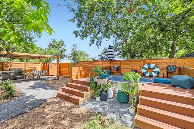 view of yard with a jacuzzi, a fenced backyard, and a patio area