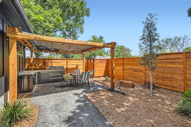 view of patio / terrace with outdoor dining area, a fenced backyard, and grilling area