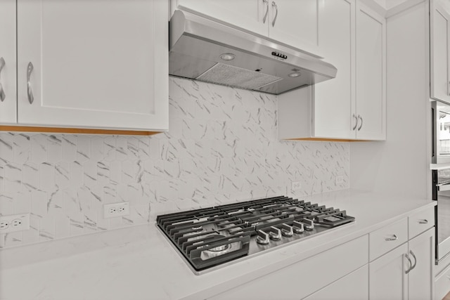 204 Camille St, Leander, TX 78641 - kitchen featuring under cabinet range hood, stainless steel gas stovetop, backsplash, and light countertops