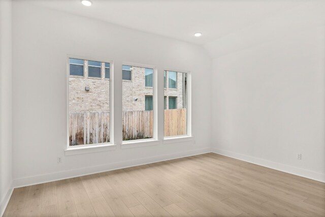 204 Camille St, Leander, TX 78641 - unfurnished room featuring plenty of natural light, light wood-type flooring, baseboards, lofted ceiling, and recessed lighting