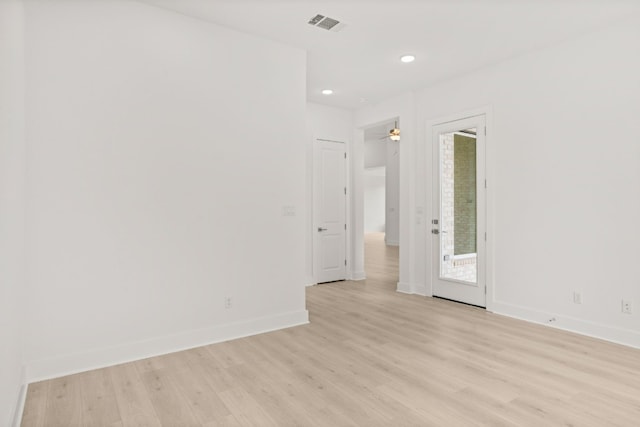 empty room with light wood-type flooring and ceiling fan