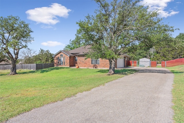 ranch-style house featuring a front lawn and a garage