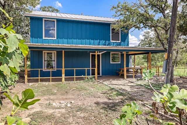 back of house featuring covered porch