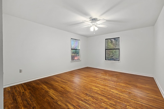 spare room featuring hardwood / wood-style floors and ceiling fan