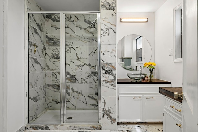 bathroom with a shower with shower door and vanity