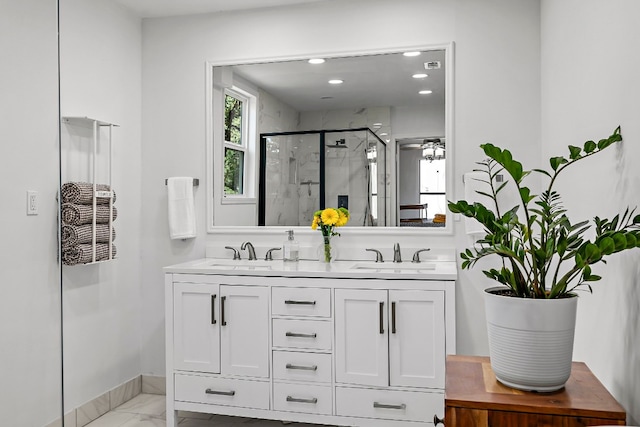 bathroom with vanity and a shower with door