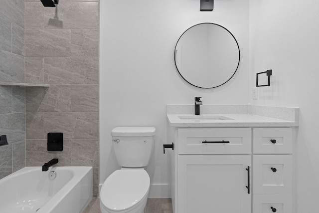 full bathroom featuring vanity, tiled shower / bath, and toilet