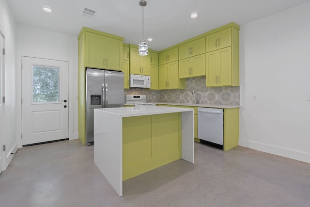 kitchen with sink, white appliances, a center island, decorative backsplash, and decorative light fixtures